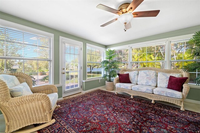 sunroom featuring a ceiling fan and a healthy amount of sunlight