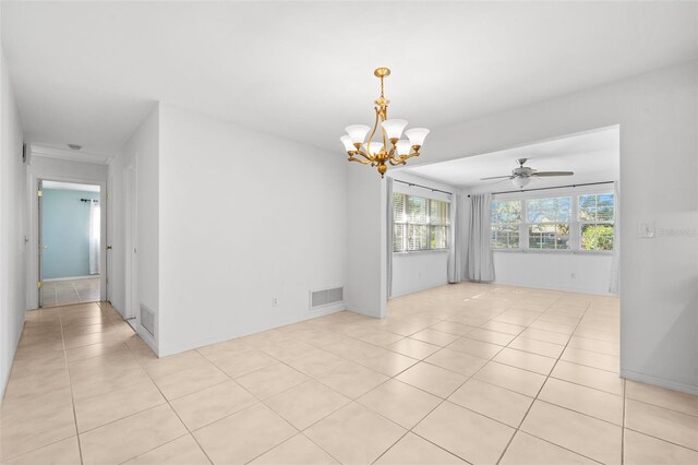 unfurnished room with ceiling fan with notable chandelier, light tile patterned flooring, and visible vents