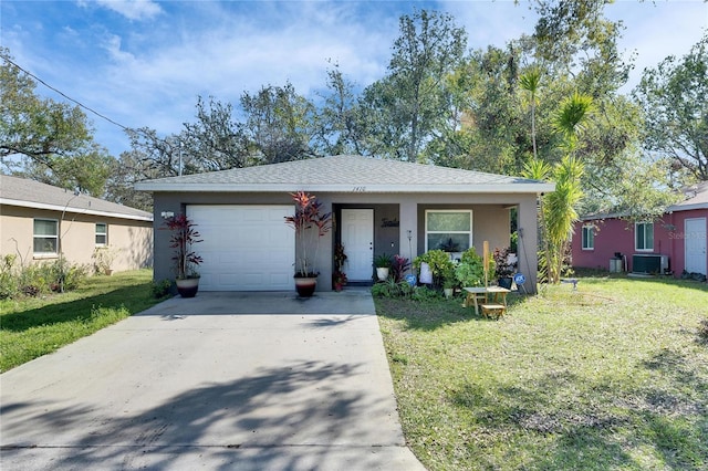 ranch-style house with a garage, driveway, a front lawn, and central air condition unit