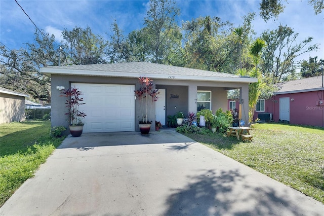 view of front of property featuring an attached garage, cooling unit, concrete driveway, stucco siding, and a front yard