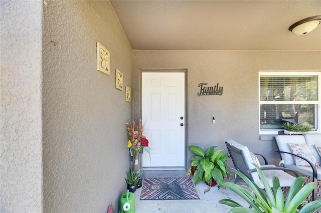 doorway to property with stucco siding