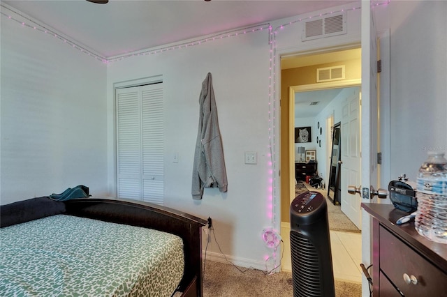 bedroom featuring light carpet, a closet, visible vents, and baseboards