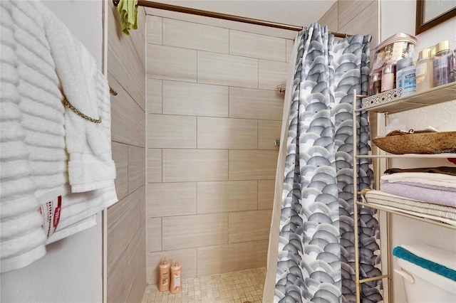 bathroom with a tile shower and toilet