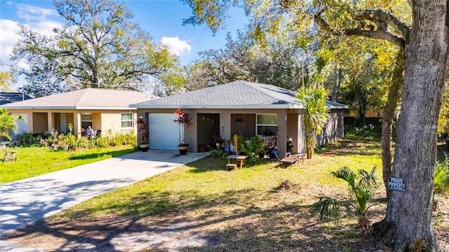 ranch-style home with a garage, driveway, a front lawn, and stucco siding