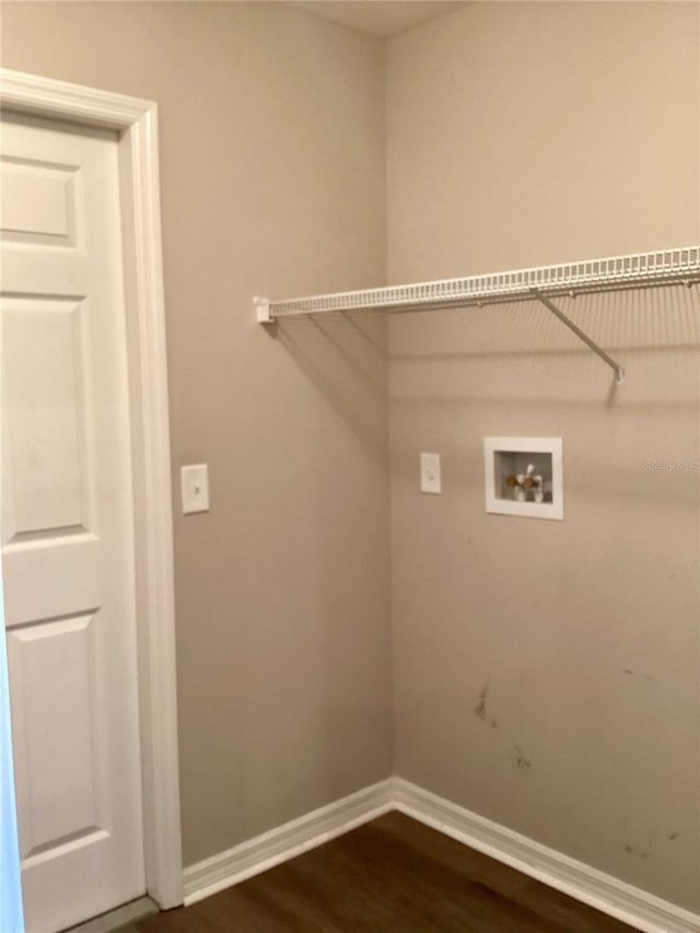 laundry room featuring dark wood-type flooring, laundry area, hookup for a washing machine, and baseboards