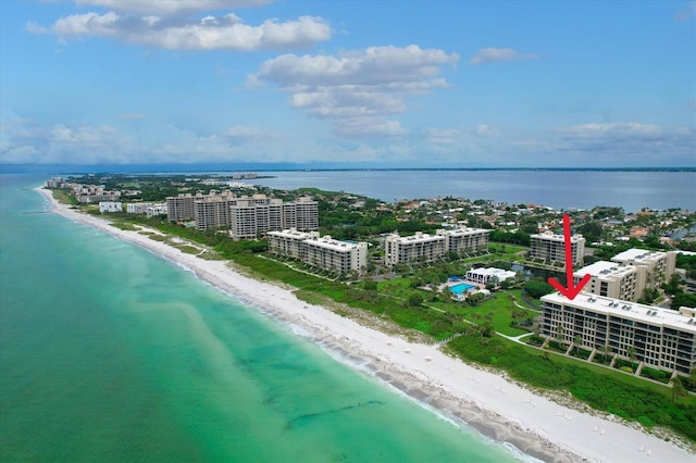 aerial view featuring a city view, a beach view, and a water view