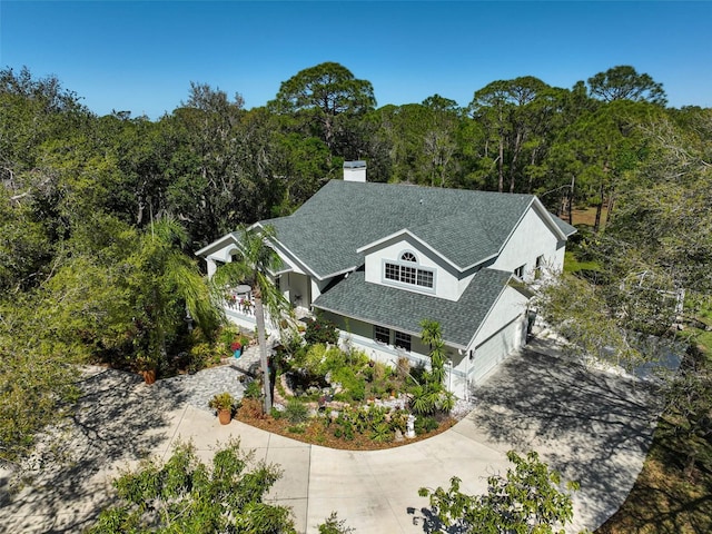 birds eye view of property with a forest view