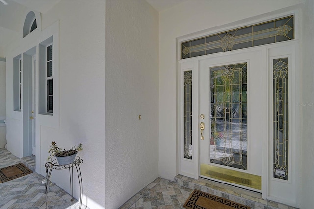 doorway to property with stucco siding