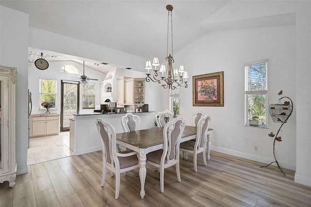 dining area with lofted ceiling, a healthy amount of sunlight, and light wood-style floors