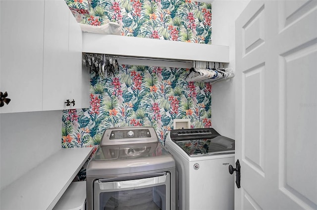 laundry area with cabinet space and separate washer and dryer