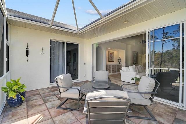 view of patio featuring glass enclosure and an outdoor hangout area