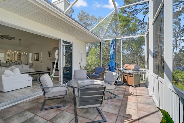 sunroom featuring a notable chandelier