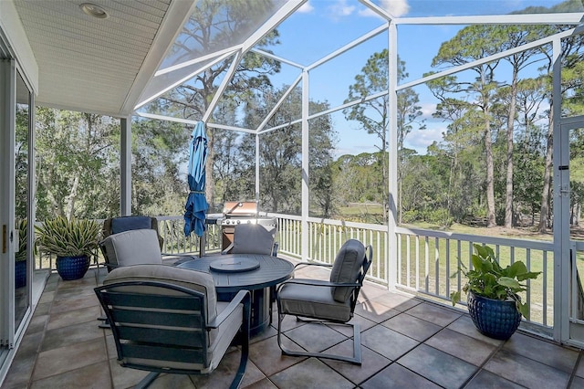 sunroom / solarium featuring lofted ceiling