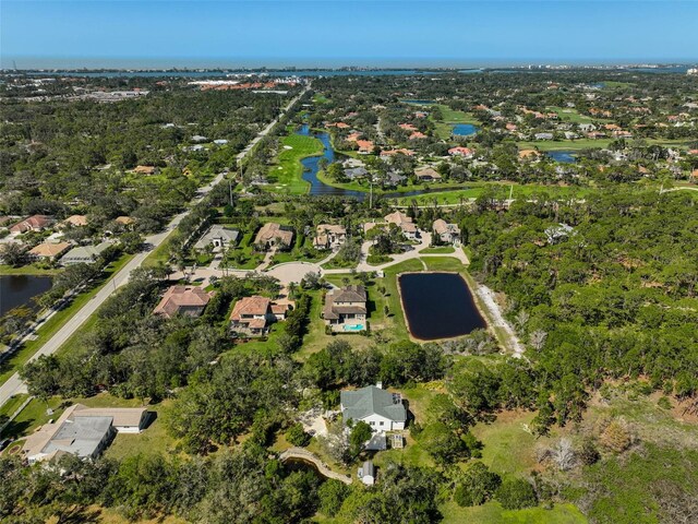 birds eye view of property with a residential view and a water view