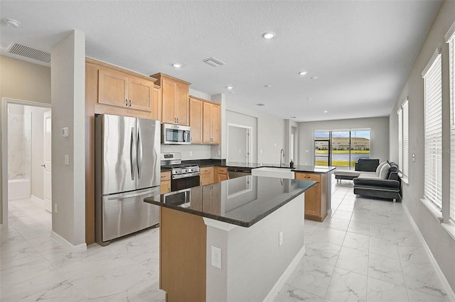 kitchen featuring visible vents, marble finish floor, appliances with stainless steel finishes, and a peninsula