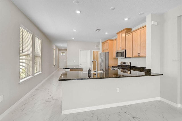 kitchen featuring stainless steel appliances, baseboards, marble finish floor, and visible vents