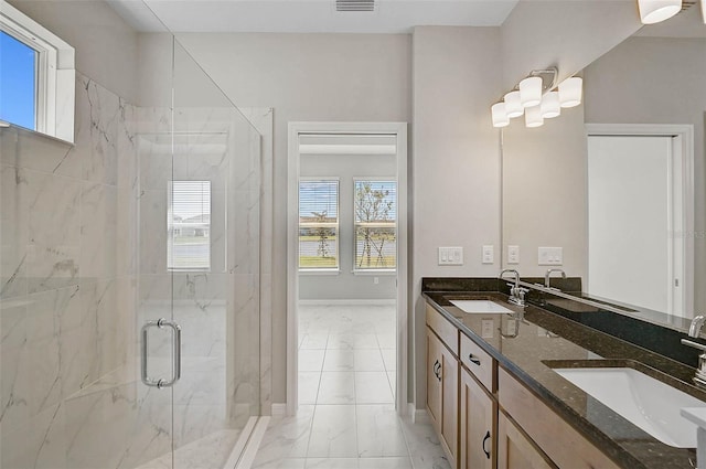 bathroom featuring a marble finish shower, marble finish floor, baseboards, and a sink