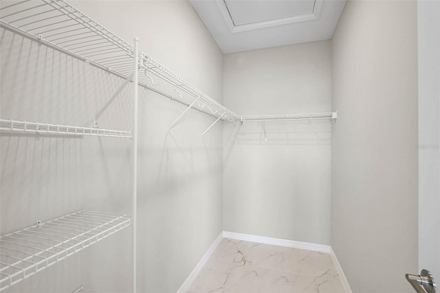 spacious closet featuring marble finish floor