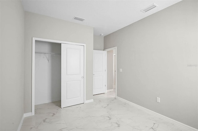 unfurnished bedroom featuring baseboards, visible vents, and marble finish floor