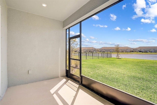 unfurnished sunroom with a water view