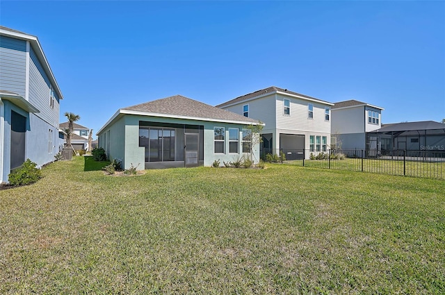 rear view of property with a yard, fence private yard, and stucco siding