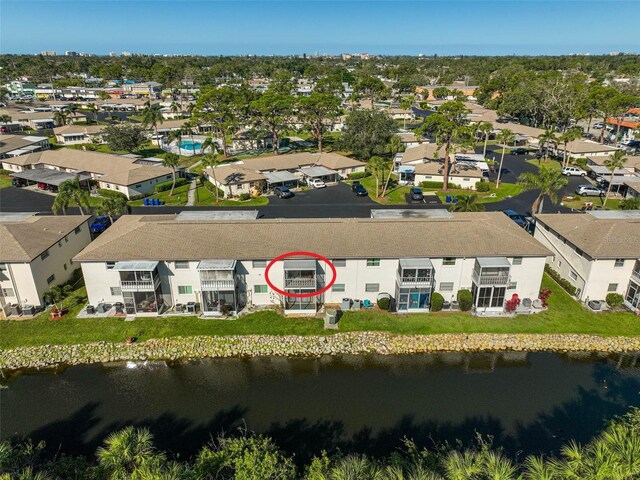 drone / aerial view with a residential view and a water view