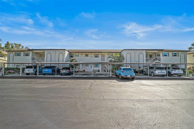 view of building exterior featuring a residential view and covered parking