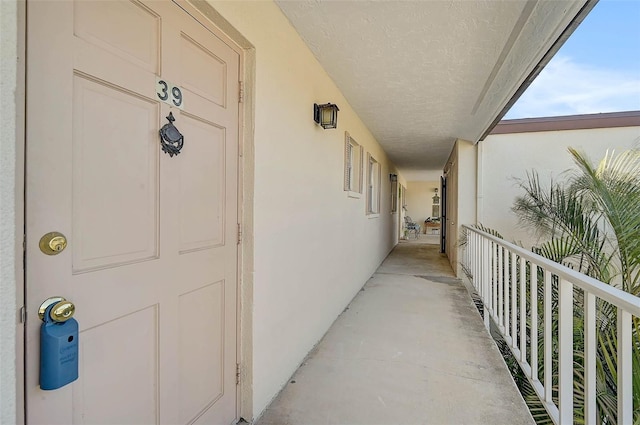 doorway to property featuring stucco siding