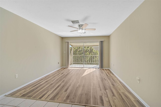 unfurnished room featuring visible vents, ceiling fan, light wood-type flooring, and baseboards