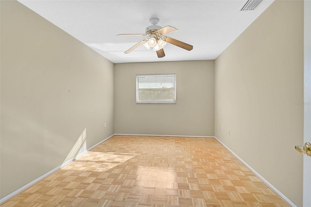 spare room featuring visible vents, baseboards, and a ceiling fan