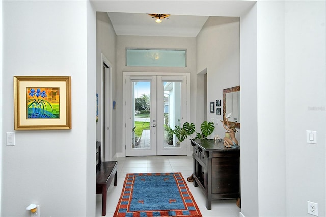 doorway to outside with french doors and light tile patterned flooring