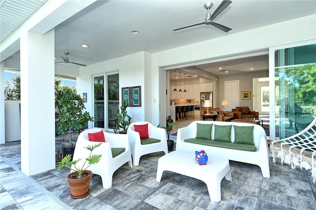 view of patio / terrace with ceiling fan, an outdoor living space, and a sink