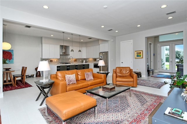 living room featuring visible vents, french doors, and recessed lighting