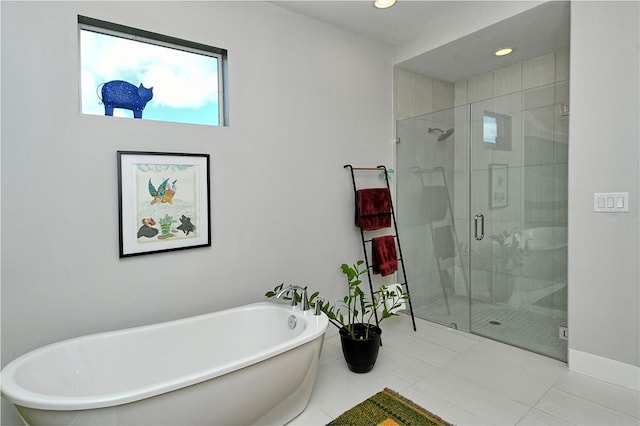 bathroom featuring a freestanding bath, a stall shower, recessed lighting, and baseboards