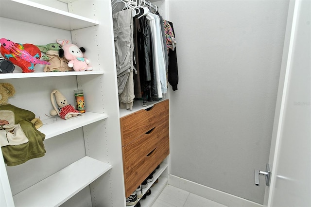 walk in closet with tile patterned floors