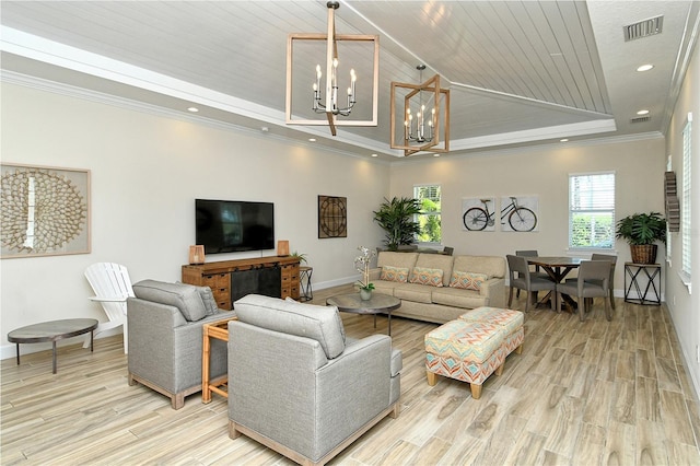 living room featuring a tray ceiling, crown molding, a notable chandelier, visible vents, and wooden ceiling