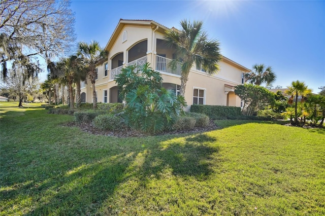 view of home's exterior with a yard and stucco siding