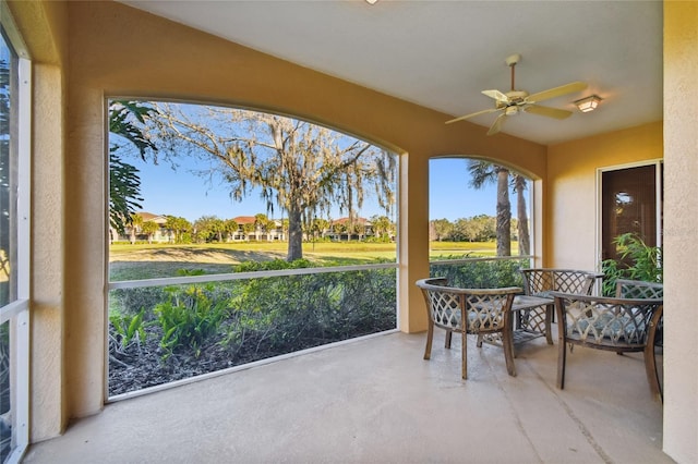 sunroom / solarium featuring ceiling fan