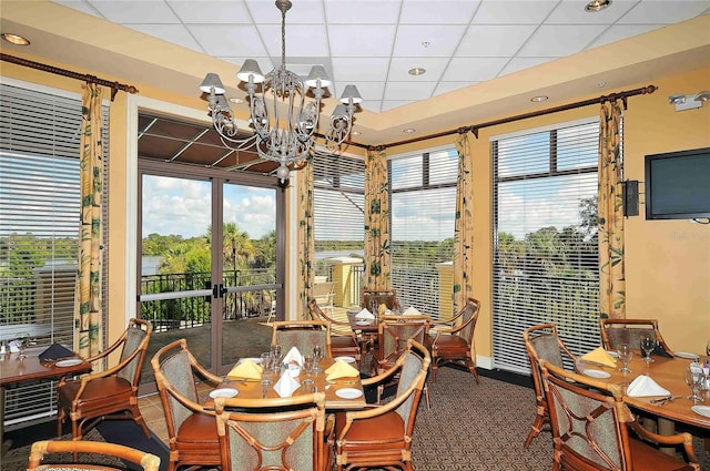 dining room featuring a notable chandelier and a paneled ceiling