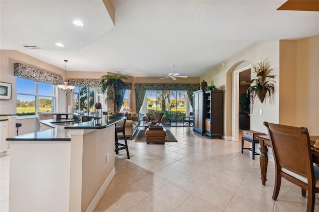 kitchen with visible vents, dark countertops, a healthy amount of sunlight, and open floor plan