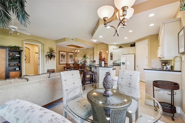 dining room featuring visible vents, recessed lighting, an inviting chandelier, light tile patterned flooring, and arched walkways