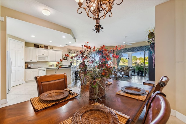 dining space with recessed lighting, baseboards, light tile patterned floors, and ceiling fan with notable chandelier