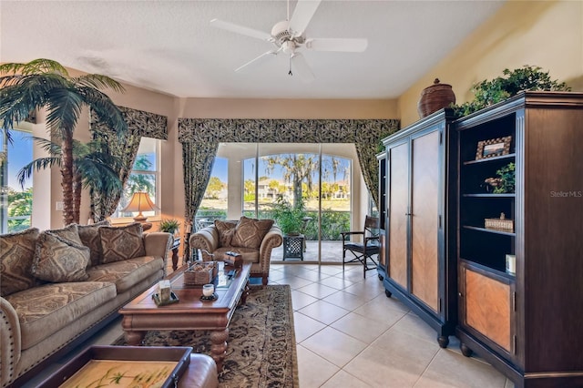 living room with light tile patterned flooring and a ceiling fan