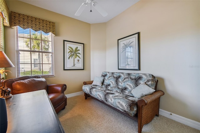 carpeted living room featuring a ceiling fan and baseboards