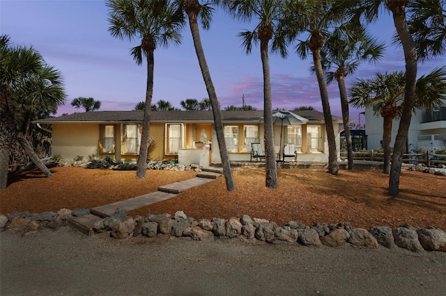 single story home with fence and stucco siding