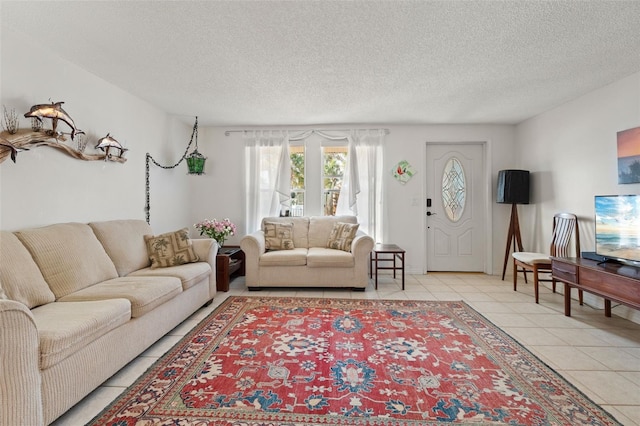 living area with light tile patterned floors and a textured ceiling