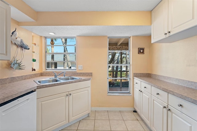 kitchen featuring light tile patterned floors, white dishwasher, a sink, white cabinets, and light countertops