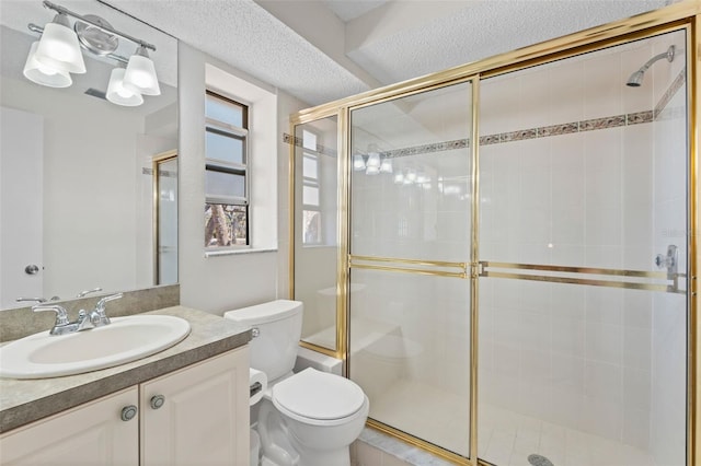 full bath with a textured ceiling, vanity, a shower stall, and toilet