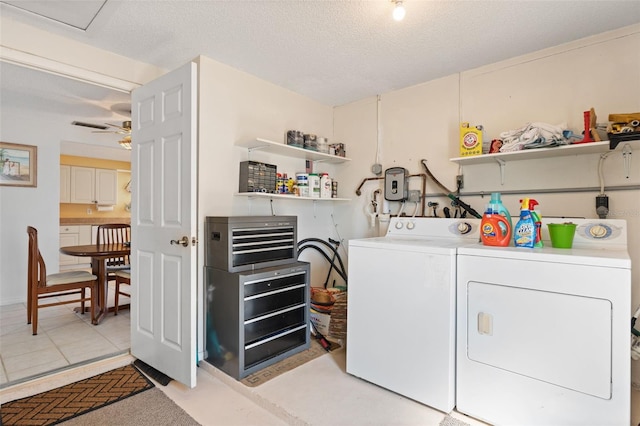 washroom with laundry area, a textured ceiling, and washer and dryer