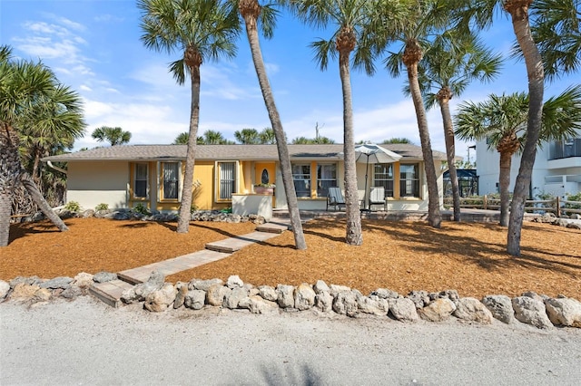 single story home with fence and stucco siding